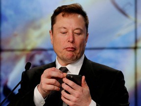 Elon Musk looks at his mobile phone in Cape Canaveral, Fla., Jan. 19, 2020.