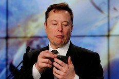 Elon Musk looks at his mobile phone in Cape Canaveral, Fla., Jan. 19, 2020.