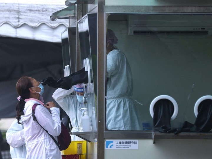  A woman receives a COVID-19 test amid the coronavirus outbreak in Taipei, Taiwan, Thursday, May 12, 2022.