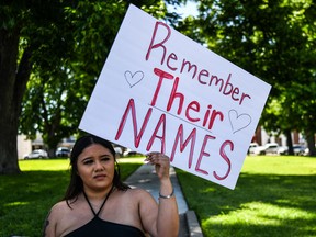 TOPSHOT - A local resident holds a placard that reads  Prayers 4 Uvalde as they grieve for the victims of the mass shooting at Robb Elementary School in Uvalde, Texas, on May 25, 2022. - The tight-knit Latino community of Uvalde was wracked with grief Wednesday after a teen in body armor marched into the school and killed 19 children and two teachers, in the latest spasm of deadly gun violence in the US. (Photo by CHANDAN KHANNA / AFP) (Photo by CHANDAN KHANNA/AFP via Getty Images)