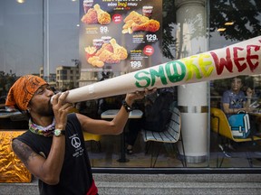A Thai activist holds up a prop joint that says “smoke weed” during a pro marijuana rally on April 20, 2022 in Bangkok. Lauren DeCicca/Getty Images