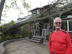 A massive tree snapped at the front of Scott Chamberlain's home on Seabreeze Dr. in Ajax, causing massive damage. He is pictured on May 22, 2022.