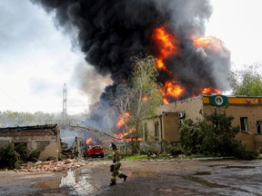 Smoke rises above a burning oil storage facility on the outskirts of Donetsk, Ukraine May 4, 2022.