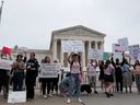 Demonstrators hold signs during a protest outside the U.S. Supreme Court after the leak of a draft majority opinion written by Justice Samuel Alito preparing for a majority of the court to overturn the landmark Roe v. Wade abortion rights decision later this year, in Washington, May 4, 2022.