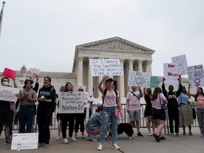 KINSELLA: Pro-choice conservatives won't tolerate threat of recriminalizing abortion - Toronto Sun 2 Demonstrators hold signs during a protest outside the U.S. Supreme Court after the leak of a draft majority opinion written by Justice Samuel Alito preparing for a majority of the court to overturn the landmark Roe v. Wade abortion rights decision later this year, in Washington, May 4, 2022.