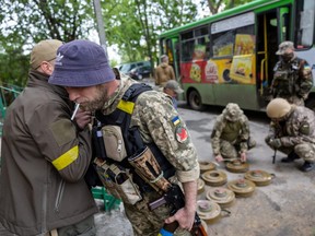 Ukrainian soldiers deactivate anti tank mines before moving them to the frontline positions nearer to Russian troops on Sunday, May 15, 2022 in Kharkiv, Ukraine.