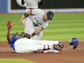 Blue Jays' Vladimir Guerrero Jr. slides into second base on a double as New York Yankees second baseman Gleyber Torres applies a late tag during the fourth inning at Rogers Centre on Tuesday, May 3, 2022.