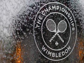 In this file photo a water feature with the Wimbledon logo stands by the members area at the All England Tennis Club in Wimbledon, southwest London, on July 1, 2018, on the eve of the 2018 Wimbledon Championships tennis tournament.