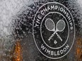 In this file photo a water feature with the Wimbledon logo stands by the members area at the All England Tennis Club in Wimbledon, southwest London, on July 1, 2018, on the eve of the 2018 Wimbledon Championships tennis tournament.