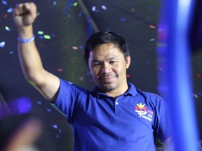 This photo taken on May 7, 2022 shows Philippine boxing icon and presidential candidate Manny Pacquiao raising a clinched fist during a campaign rally in General Santos City, on the southern island of Mindanao.