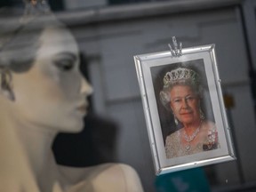 A portrait of Queen Elizabeth II is pictured in a shop window in Colchester, eastern England on May 31, 2022, as preparations get underway ahead of the Queen's Platinum Jubilee celebrations which are set to begin on Thursday.