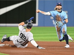 May 4, 2022; Toronto, Ontario, CAN; Toronto Blue Jays shortstop Bo Bichette (11) can't convert a double play after forcing New York Yankees right fielder Aaron Judge in the fourth inning at Rogers Center.