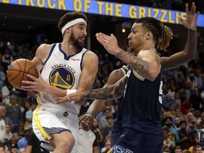 Golden State Warriors goaltender Klay Thompson heads for the basket as Memphis Grizzlies forward Brandon Clarke defends during the second half of Game 2 of the 2022 NBA Playoffs Second Round at FedExForum.