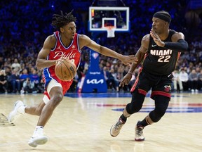May 8, 2022; Philadelphia, Pennsylvania, USA; Philadelphia 76ers guard Tyrese Maxey dribbles the ball against Miami Heat forward Jimmy Butler  during the third quarter in game four of the second round for the 2022 NBA playoffs at Wells Fargo Center.