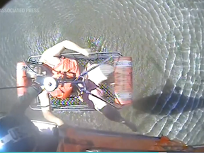 A screenshot from video of a survivor of a Georgia boating crash being rescued.