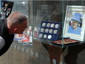 A customer looks at commemorative souvenirs outside a shop in Strand ahead of planned celebrations for the Queen's Platinum Jubilee in London, Britain, May 21, 2022.