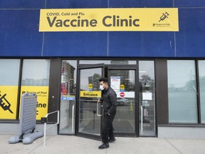 A staff member at a vaccine clinic looks outside the clinic for people waiting to get their COVID-19 vaccine in Mississauga, Ont., on Wednesday, April 13, 2022.