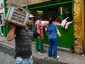 People buy meat in a market of Havana, on May 31, 2022.