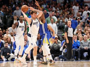 Dallas Mavericks guard Luka Doncic (77) controls the ball while defended by Golden State Warriors forward Draymond Green (23) during the third quarter in game four of the 2022 Western Conference finals at American Airlines Center in Dallas, May 24, 2022.