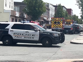Fall River Police vehicle blocking off taped-off area at scene of fight involving 50 to 100 bikers.