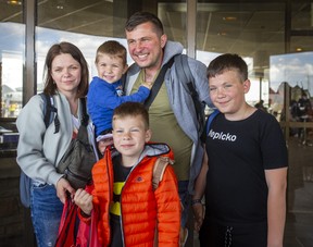 Roman and Olha Koval, and their three children, Oleh, 11, Taras, 7, and Yurii, 3, are among a group of people fleeing war from Ukraine who arrive at a terminal at Pearson International Airport in Toronto on a plane from Poland.  operated by Samaritan's Purse Canada on Sunday, May 15, 2022. ERNEST DOROSZUK/TORONTO SUN