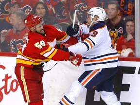 Calgary Flames Oliver Kylington battles Edmonton Oilers Leon Draisaitl in second period NHL action at the Scotiabank Saddledome in Calgary on Monday, March 7, 2022.