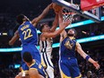 Memphis Grizzlies guard Desmond Bane, centre,  has his shot blocked by Golden State Warriors forward Andrew Wiggins, left, and guard Klay Thompson in the second quarter during Game 6 of the second round for the 2022 NBA playoffs at Chase Center in San Francisco, Calif., May 13, 2022.