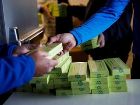 A worker hands out coronavirus disease (COVID-19) antigen test kits, as the latest Omicron variant emerges as a threat, at Yorkdale Mall in Toronto, Ontario, Canada December 22, 2021.