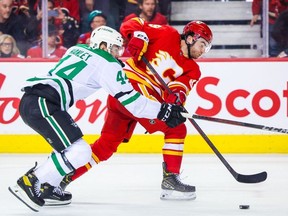 May 11, 2022; Calgary, Alberta, CAN; Calgary Flames center Dillon Dube and Dallas Stars defenseman Joel Hanley battle for the puck during the third period in game five of the first round of the 2022 Stanley Cup Playoffs at Scotiabank Saddledome.