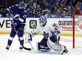 May 12, 2022; Tampa, Florida, USA; Toronto Maple Leafs goaltender Jack Campbell makes a save as Tampa Bay Lightning left wing Alex Killorn goes after the puck during the third period of game six of the first round of the 2022 Stanley Cup Playoffs at Amalie Arena.