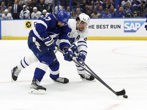 Tampa Bay Lightning left wing Alex Killorn shoots as Toronto Maple Leafs center Auston Matthews defends during the first period of game six of the first round of the 2022 Stanley Cup Playoffs at Amalie Arena.