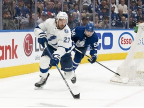 Toronto Maple Leafs left wing Michael Bunting battles for the puck with Tampa Bay Lightning defenceman Ryan McDonagh at Scotiabank Arena.