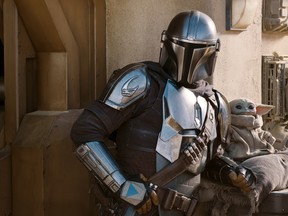 Pedro Pascal as the Mandalorian along with Grogu in a scene from Season 2 of the Star Wars spinoff.