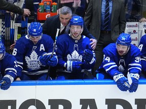 Toronto Maple Leafs head coach Sheldon Keefe congratulates Mitchell Marner (16) and forward Michael Bunting (58) on assisting on the goal by forward Auston Matthews (34) against the Tampa Bay Lightning during the third period of game five of the first round of the 2022 Stanley Cup Playoffs at Scotiabank Arena.