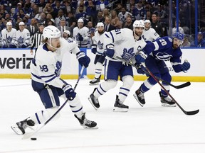 Toronto Maple Leafs right wing William Nylander, left, shoots against the Tampa Bay Lightning during overtime of Game 6 of the first round of the 2022 Stanley Cup Playoffs at Amalie Arena in Tampa, Fla., May 12, 2022.