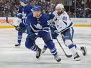 Nikita Kucherov of the Tampa Bay Lightning plays against Justin Hall of the Toronto Maple Leafs during Game 5 of the first round of the 2022 Stanley Cup Playoffs at the Scotiabank Arena on May 10, 2022 in Toronto.