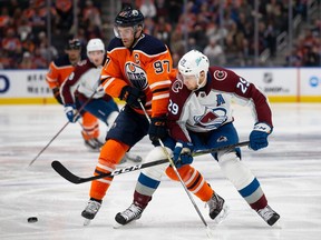 Connor McDavid #97 of the Edmonton Oilers battles against Nathan MacKinnon #29 of the Colorado Avalanche during the second period at Rogers Place on April 9, 2022