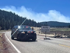 A police roadblock is placed, stopping people entering the area near Holman which is the northern edge of the Hermits Peak Calf Canyon wildfire, near Angostura, New Mexico May 9, 2022.