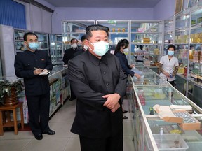 This picture taken on May 15, 2022 and released from North Korea's official Korean Central News Agency (KCNA) on May 16 shows North Korean leader Kim Jong Un inspecting a pharmacy in Pyongyang.