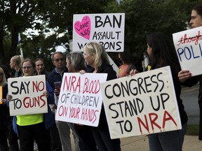 Gun-control advocates hold a vigil outside of the National Rifle Association (NRA) headquarters following the recent mass shooting at Robb Elementary School on May 25, 2022 in Fairfax, Va.