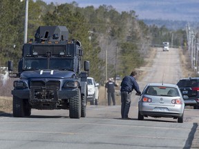 Police block the highway in Debert, N.S., on Sunday, April 19, 2020. The RCMP have taken Gabriel Wortman, 51, into custody after an incident in Portapique, N.S., where several people were shot. A report on how the RCMP handled the first scene of the 2020 Nova Scotia mass shooting indicates five of the victims weren't found until about 18 hours after the killer fled.