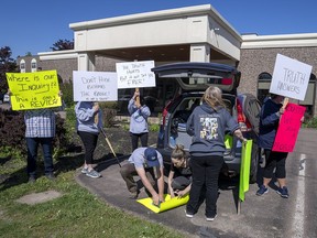 Family and friends of the victims protest outside the hotel where the Mass Casualty Commission inquiry into the April 2020 mass murders in rural Nova Scotia, is being held in Truro, N.S. on Thursday, May 26, 2022.