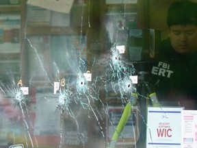 An investigator works at the scene of a shooting at a supermarket, in Buffalo, N.Y., Monday, May 16, 2022.