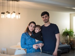 Graziela Cariello and Thiago Lang pose for a photograph with their 19-month-old son Pedro at their home in Barrie, Ont., on Monday, April 25, 2022.