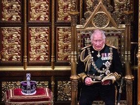 Prince Charles reads the Queen's Speech as he sits by the Imperial State Crown in the House of Lords Chamber, during the State Opening of Parliament in the House of Lords at the Palace of Westminster on May 10, 2022 in London.