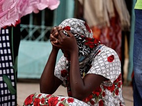 Kaba, a mother of a ten-day-old baby, reacts as she sits outside the hospital, where newborn babies died in a fire at the neonatal section of a regional hospital in Tivaouane, Senegal, May 26, 2022.