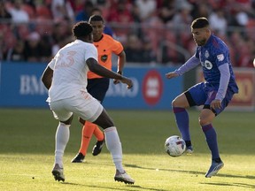 Toronto FC midfielder Alejandro Pozuelo controls the ball against Chicago Fire defender Carlos Teran during the first half at BMO Field.