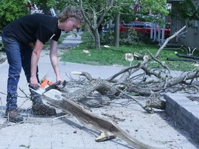Residents in Uxbridge on Monday were clearing debris left by Saturday's deadly storm.