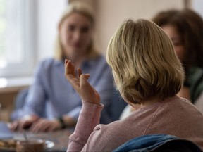 A woman tells her story as psychologists listen during a counseling session for Ukrainians displaced by war on May 3, 2022 in Kryvyi Rih, Ukraine.
