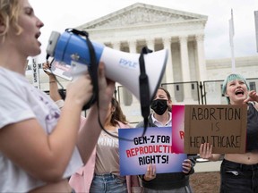 Pro-choice demonstrators chant in front of un-scalable fence that stands around the U.S. Supreme Court in Washington, D.C., on May 5, 2022.